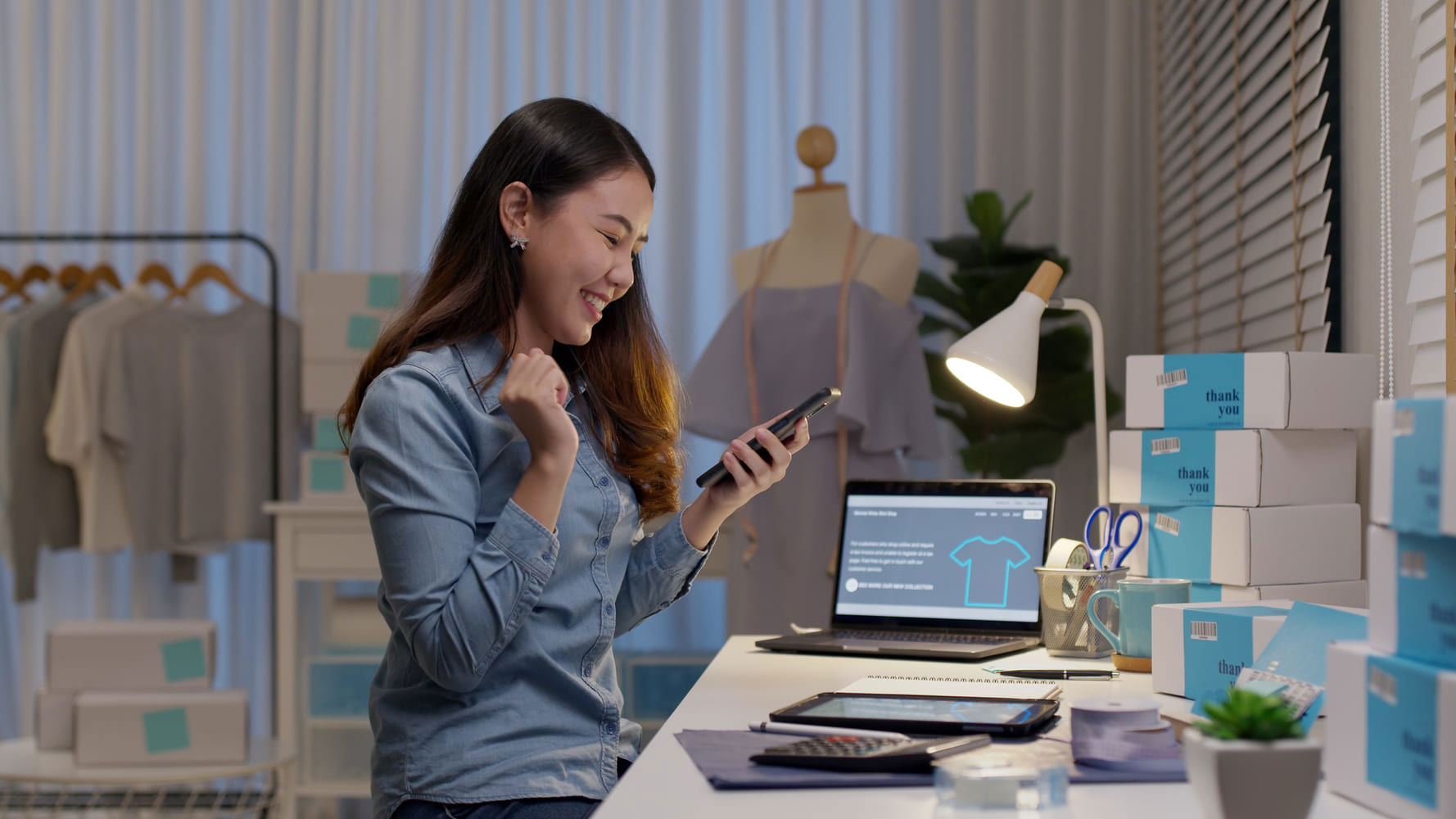 Saleswoman celebrating on cellphone