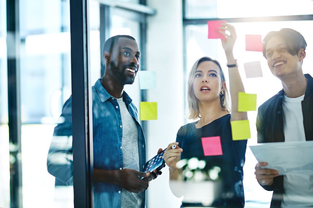 Team planning strategies on a glass board