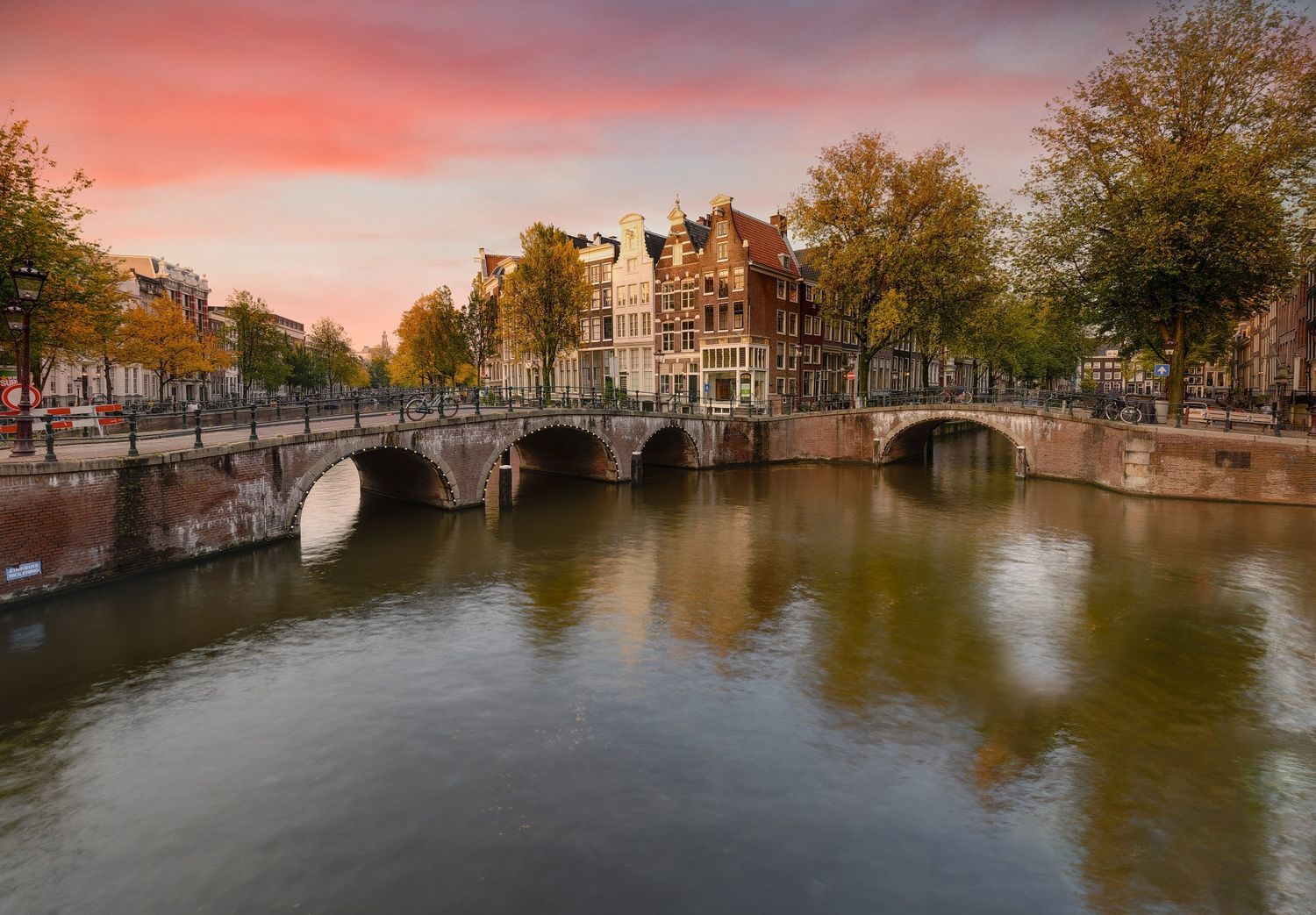 Canal in a Dutch city with historic buildings and calm water.