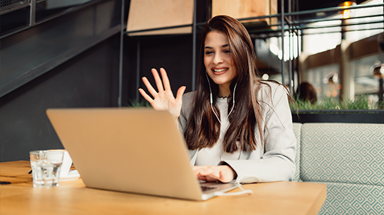 Woman waving during a video call