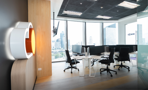 A bright, modern office workspace with city skyline views.